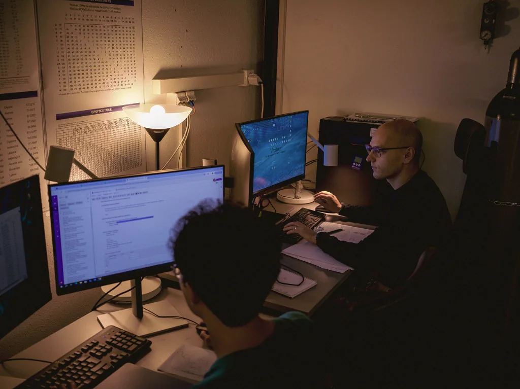 Peptone scientists reviewing computational results together at a workstation