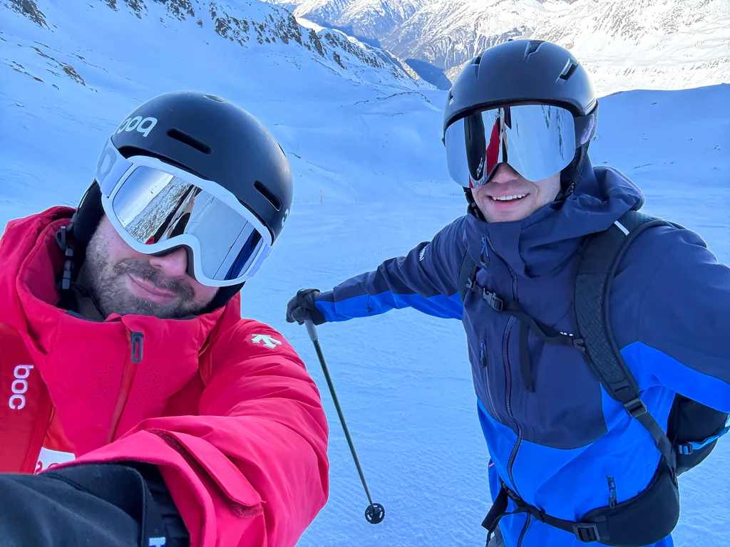 Two Peptone team members pausing between runs beneath a clear winter sky